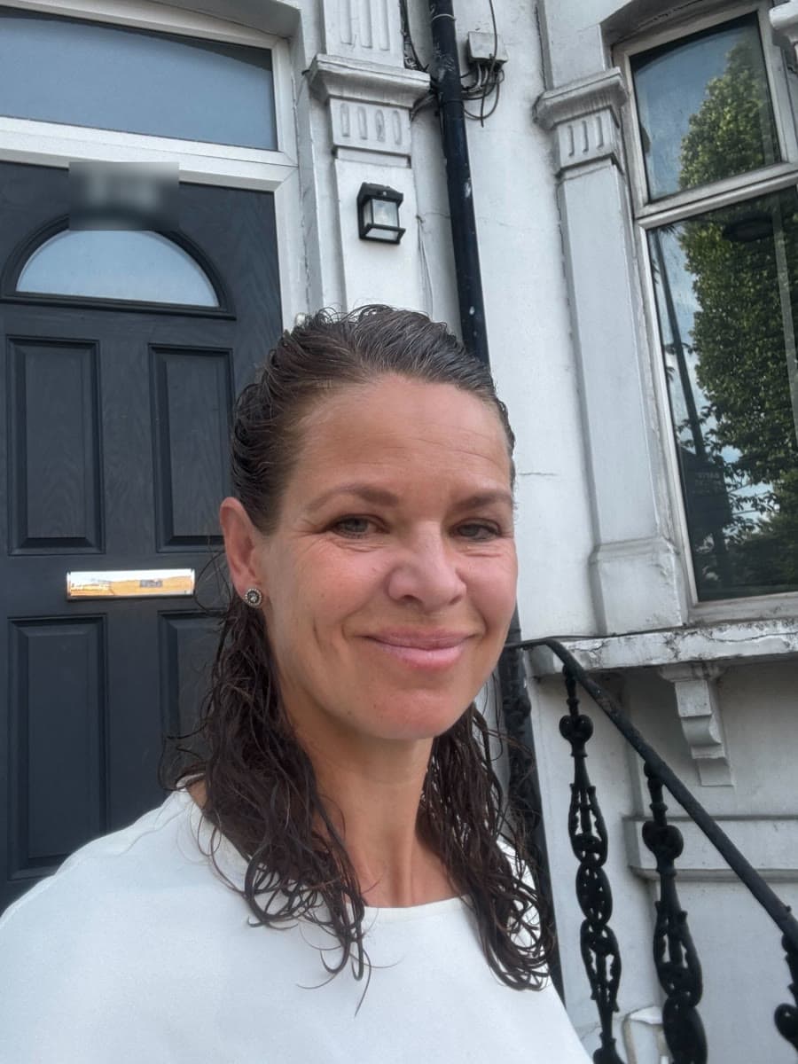 A Unibloom team member outside a townhouse
